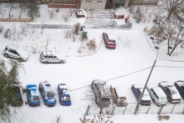 Yukarıdan arabalar kar yağışı kar ile kaplı sonra binanın konut mekâna görüntüleyin. Seçici odak