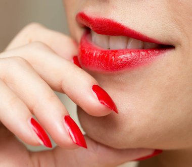 Kırmızı manikür ve kırmızı dudaklar
