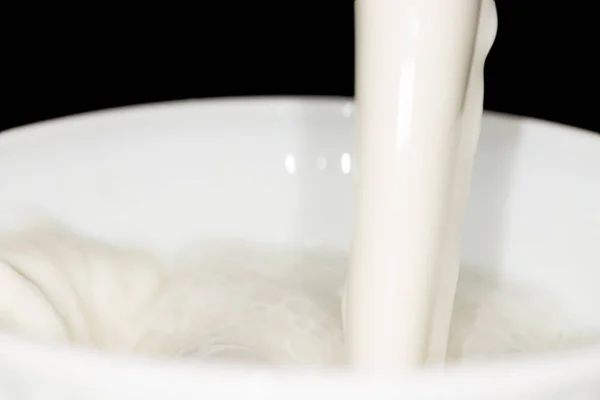 Milk splash on black background — Stock Photo, Image