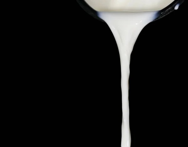 Milk on a black background — Stock Photo, Image