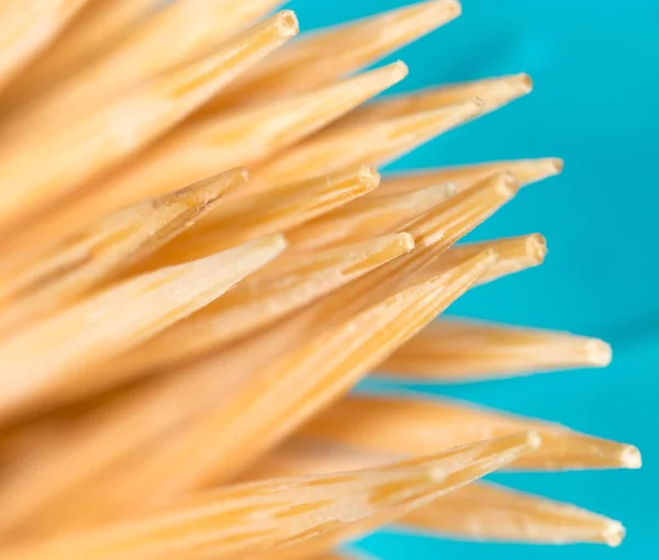 Toothpicks on a blue background. macro — Stock Photo, Image