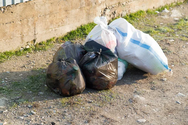 Garbage in bags in nature — Stock Photo, Image