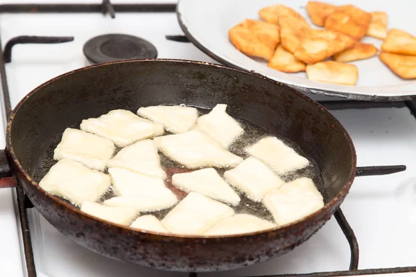 Donuts fried in a pan — Stock Photo, Image