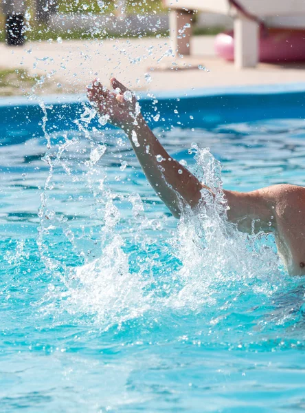 Splashing water with a hand in the pool — Stock Photo, Image