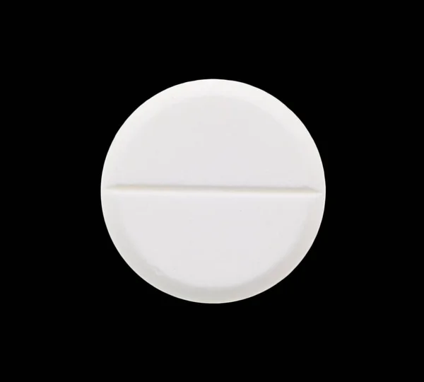 Tabletas médicas sobre fondo negro — Foto de Stock