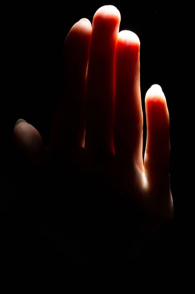 Hand on a black background — Stock Photo, Image