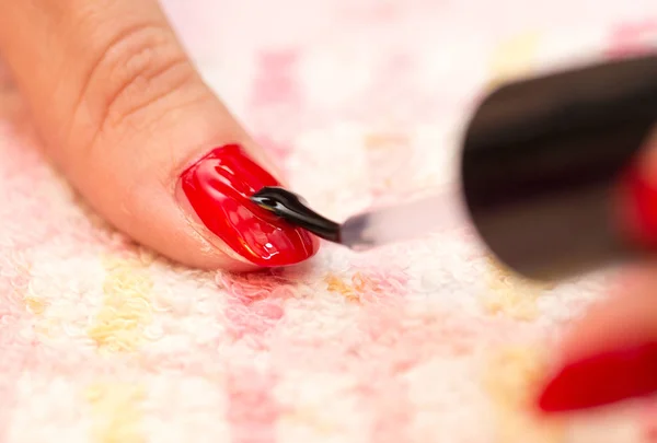 Malované nehty Červený lak na nehty v salonu krásy — Stock fotografie