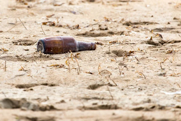 Glass bottle in the sand — Stock Photo, Image