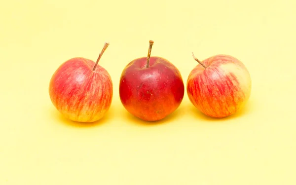 Спелые яблоки на желтом фоне — стоковое фото
