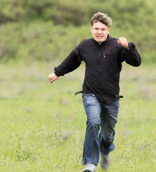 Man running in a meadow — Stock Photo, Image
