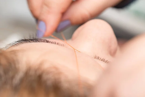 Aseo el hilo de las cejas en un salón de belleza. cerrar —  Fotos de Stock