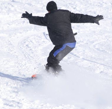 İnsanlar kışın karda snowboard yapıyor.
