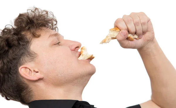 Homme mange du pain sur un fond blanc — Photo