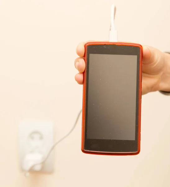 Cell phone charging in your hand — Stock Photo, Image