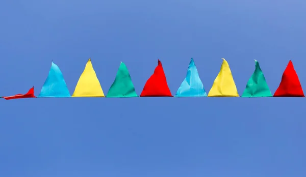 Multicolored flags against the blue sky — Stock Photo, Image