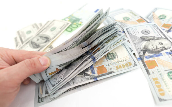 Dollars in hand on a white background