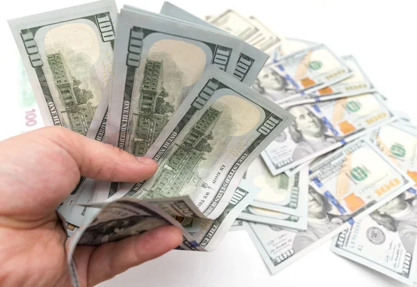 Dollars in de hand op een witte achtergrond — Stockfoto