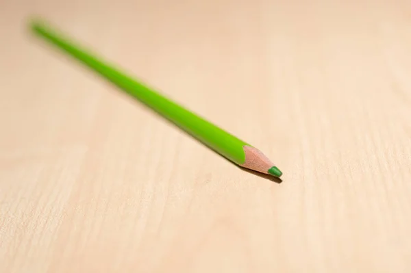 Green pencil on wooden background — Stock Photo, Image