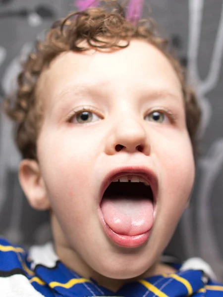 Portrait of a boy showing tongue — Stock Photo, Image