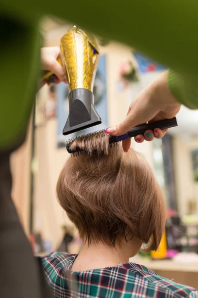 Hairdresser dries the hair dryer blond  hair — Stock Photo, Image