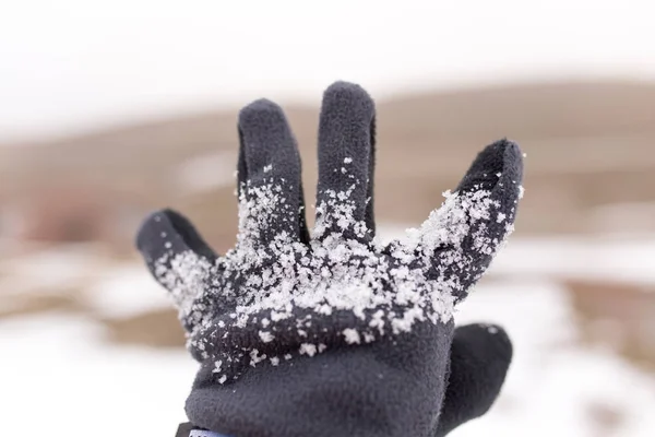Snow on the mitten on the hand — Stock Photo, Image