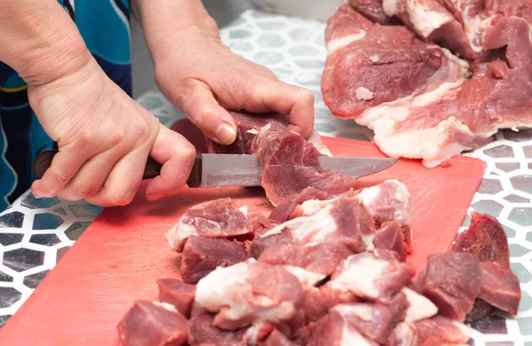 cutting meat with a knife