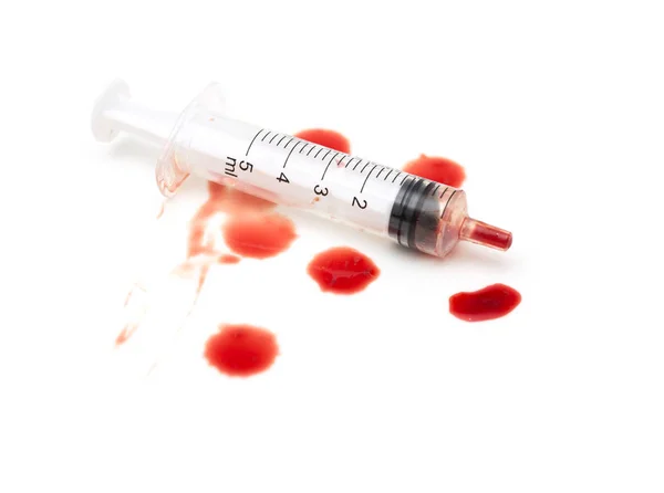 Syringe and red blood on white background — Stock Photo, Image