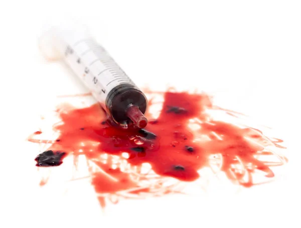 Syringe and red blood on white background — Stock Photo, Image