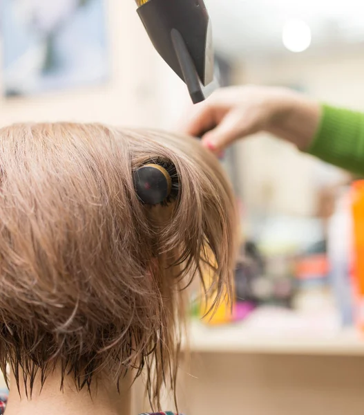 Hairdresser dries the hair dryer blond  hair — Stock Photo, Image