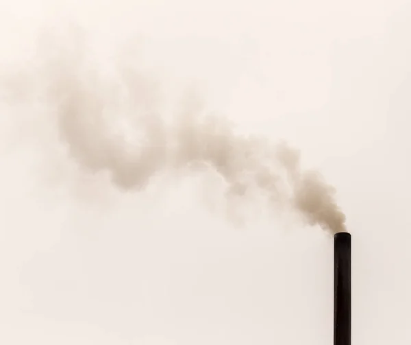 Smoke from a pipe on a cloudy sky — Stock Photo, Image