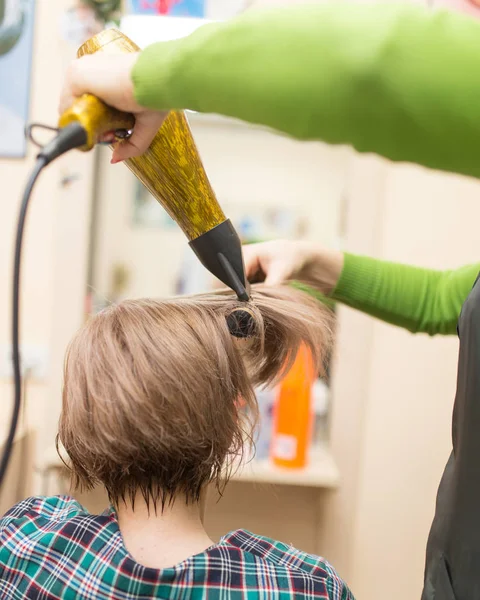 Hairdresser dries the hair dryer blond  hair — Stock Photo, Image