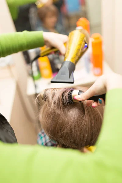 Hairdresser dries the hair dryer blond  hair — Stock Photo, Image
