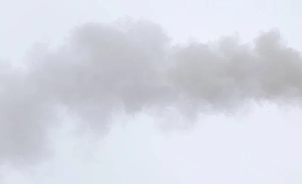 Smoke from a pipe on a cloudy sky — Stock Photo, Image