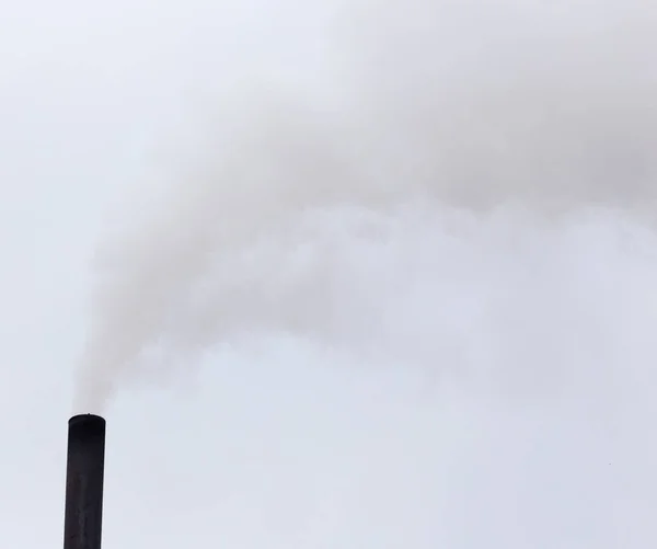 Humo de una pipa en un cielo nublado —  Fotos de Stock