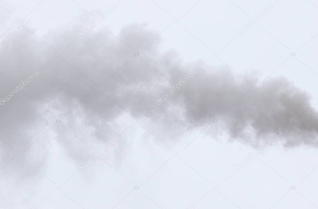 Smoke from a pipe on a cloudy sky .