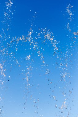 Çeşmeden akan su mavi gökyüzünün arka planında .