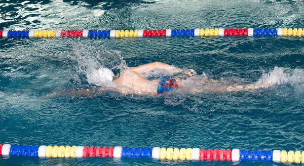 boy goes in for sports in the pool .