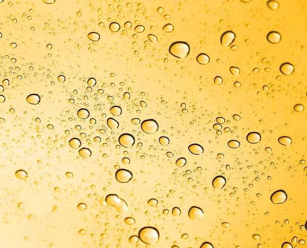 Arany Vízcseppek Üvegen Egy Absztrakt Textúra Fényképe — Stock Fotó
