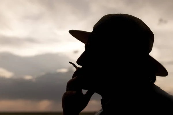 Silhueta Homem Fumando Cigarro Pôr Sol Fundo — Fotografia de Stock