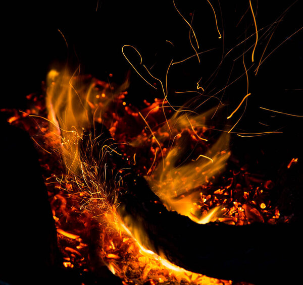 fire with sparks on a black background .