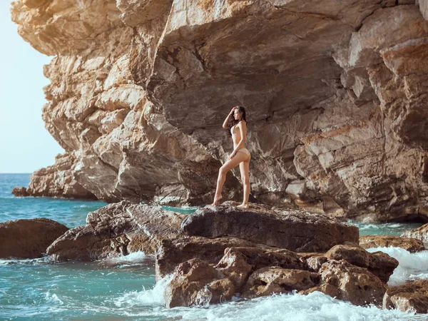 野生の岩のビーチの美しい若い女性. — ストック写真