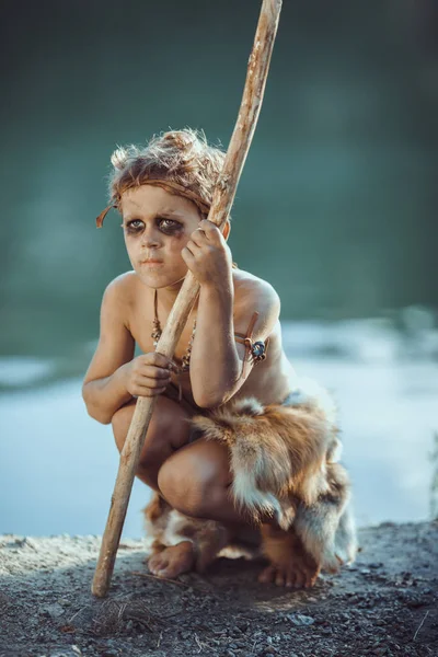 Sad caveman, manly boy with staff hunting outdoors. Ancient warrior — Stock Image Sad caveman, manly boy with staff hunting outdoors. Ancient warrior Royalty Free Stock Photos