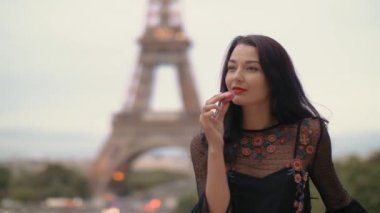 Paris 'te Eiffel Kulesi' ne karşı Fransız pastası yiyen Paris 'li kadın gülümsüyor..