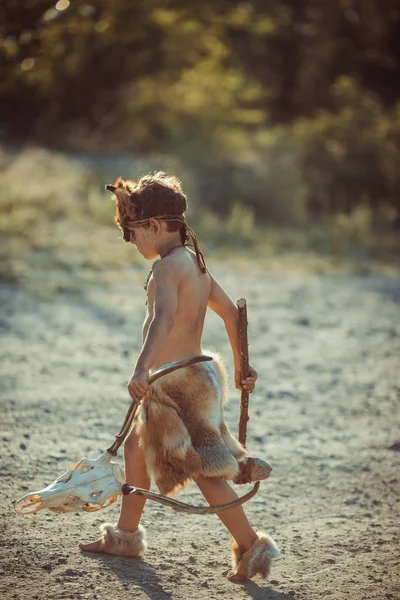 Caveman, manly boy with primitive weapon outdoors. Ancient prehistoric warrior. — Stock Image Caveman, manly boy with primitive weapon outdoors. Ancient prehistoric warrior. Stock Picture