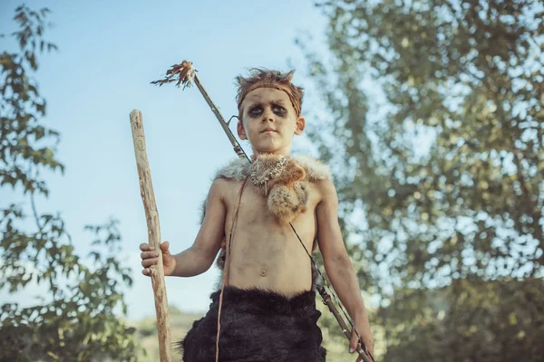 Caveman, manly boy with ancient primitive weapon hunting outdoors. Ancient warrior — Stock Image Caveman, manly boy with ancient primitive weapon hunting outdoors. Ancient warrior Royalty Free Stock Photos