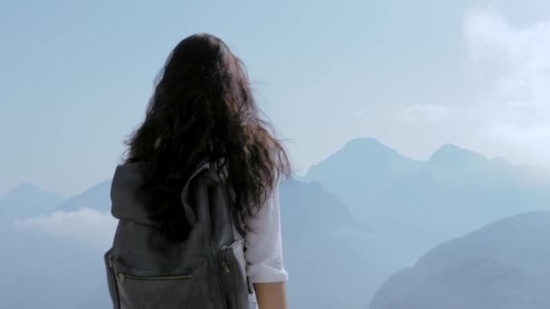 Beautiful young tourist girl with backpack at mountains — Stock Video