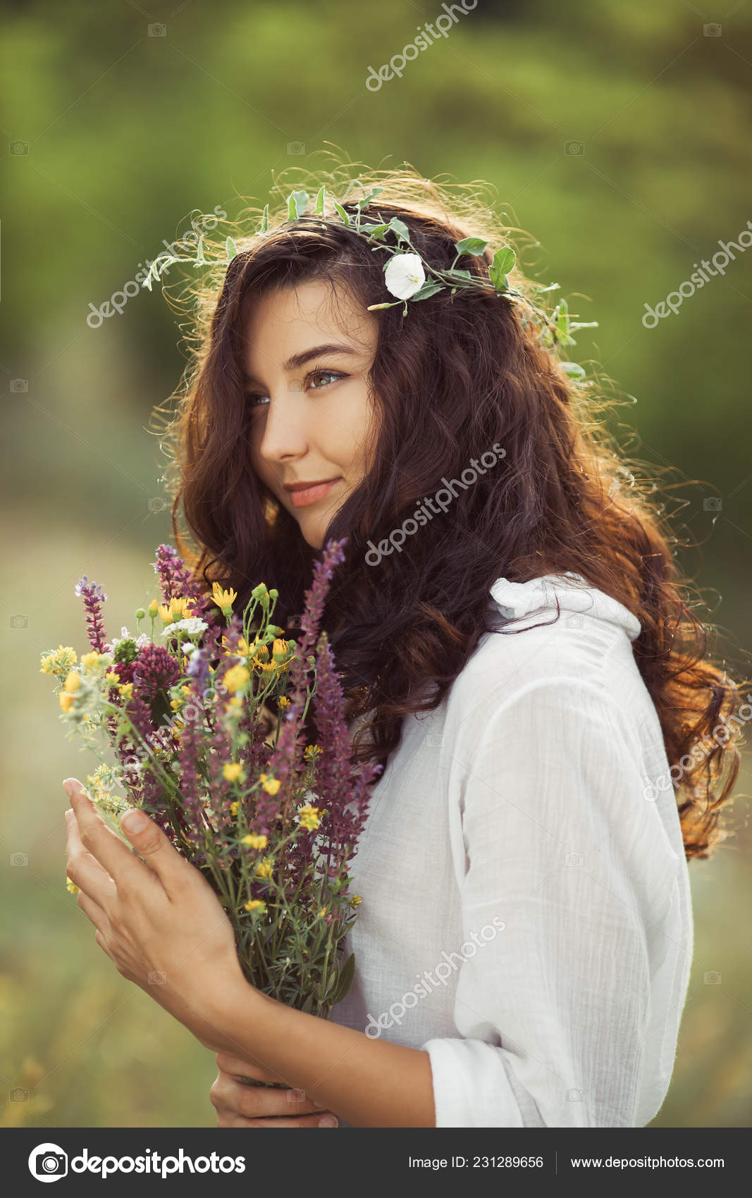 Natural beauty girl with bouquet of flowers outdoor in freedom