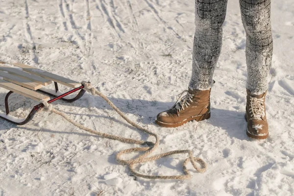 Botas de inverno na neve perto do trenó com corda . — Fotografia de Stock