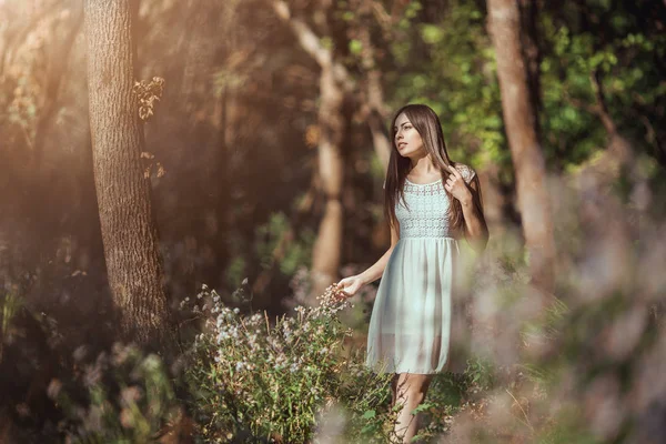 Beautiful young woman relaxing in flower medow in forest — Stock Photo, Image