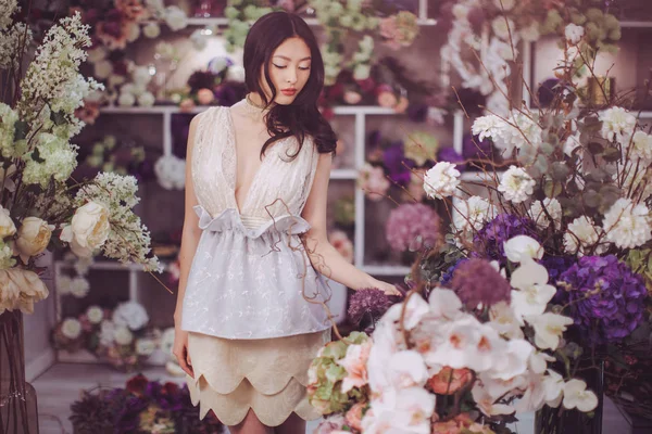 Asian woman in flower shop